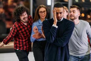 A group of young business people have fun playing interesting games while taking a break from work in a modern office. Selective focus photo