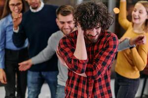 A group of young business people have fun playing interesting games while taking a break from work in a modern office. Selective focus photo