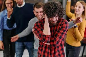 A group of young business people have fun playing interesting games while taking a break from work in a modern office. Selective focus photo