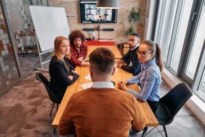 Top view of a modern startup office, a diverse team of business professionals engage in discussions on various projects and develop new business strategies, epitomizing creativity and innovation in photo