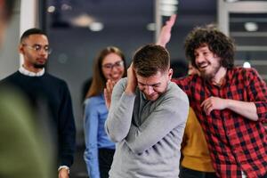 A group of young business people have fun playing interesting games while taking a break from work in a modern office. Selective focus photo