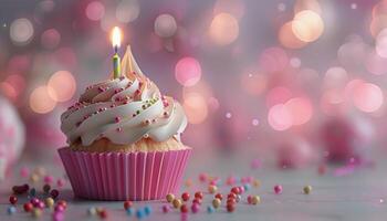 Birthday Cupcake With Candle and Sprinkles on a Light Pink Table photo