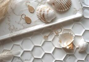 Seashell Earrings on White Hexagon Tile Background With Eucalyptus photo