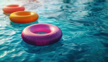 Colorful Inflatable Rings Floating in Pool Water on Sunny Day photo