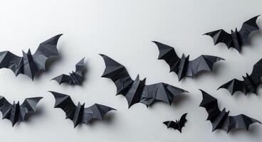 Black Paper Bats Decorated on a White Wall for Halloween photo