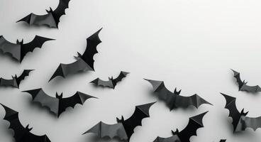 Black Paper Bats Decorated on a White Wall for Halloween photo