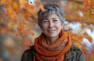 Portrait of a Woman With Gray Hair and an Orange Scarf in an Autumnal Setting photo