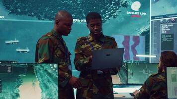 Signal support systems specialists work with battlefield data and terminal devices in military command post. Reconnaissance operators targeting enemy warships on CCTV radar. Camera A. video