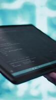 Vertical Software developer with tablet programming artificial intelligence computing simulating human brain. Close up of IT professional using device, building AI machine learning algorithms, camera B video