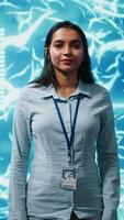 Vertical Jolly engineer using artificial intelligence computing simulating human brain thought processes. Portrait of upbeat Indian employee working with AI machine learning algorithms, camera A video