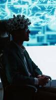 Vertical Speaker does EEG headset presentation during tech convention, demonstrating successful implementation of AI in driving forward startup businesses, sharing latest neuroscience discoveries, camera A video