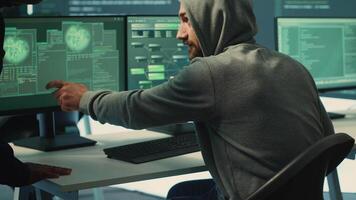 Governmental hackers doing teamwork in protecting sensitive information from cyber threats of digital mercenaries. Experts focusing on online security and cyber defense tactics. Camera A. video