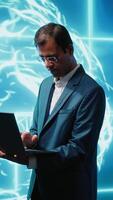 Vertical Computer scientist using laptop to implement artificial intelligence parallel processing, breaking up complex computational tasks enabling AI systems to process more input data faster, camera A video
