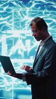 Vertical Computer scientist using laptop to implement artificial intelligence parallel processing, breaking up complex computational tasks enabling AI systems to process more input data faster, camera B video