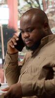 Vertical Business administrator discussing with the investors on phone call, communicating the sales numbers and performance metrics during analysis. Entrepreneur hoping to obtain new funds. Camera A. video