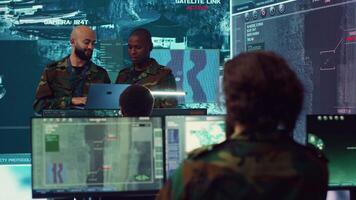 Army officers providing details for a new national safety mission, diverse team briefing their soldiers in a military base of operations. Specialists working with reconnaissance big data. Camera A. video