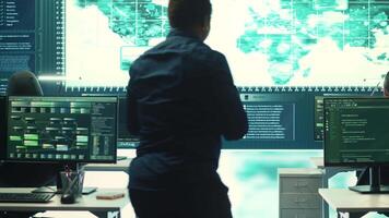 Governmental hackers exploiting network systems in high tech office, executing cyber operations for national server security. Focus on data protection and online safety to combat cybercrime. Camera A. video