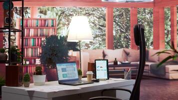 Empty home setup with tablet and laptop showing financial statistics and annual sales reports, business industry infographics. Office desk used for a consultant to study the market dynamics. video