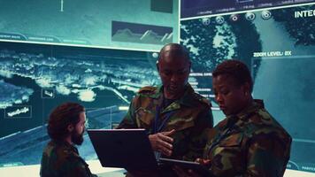 Special operations engineers examining surveillance footage to gather important information for a mission, working on reconnaissance in military headquarters. Army soldiers in command post. Camera B. video