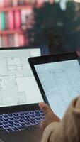 Vertical Entrepreneur planning an office relocation evaluating architectural blueprints, consulting with interior designers to create an inspiring workspace. Hunting for property leasing. Camera A. video