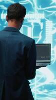 Vertical Programmers using devices and AI neural networks modeled after human brain to solve complex problems. Workers using artificial intelligence deep learning to look at data and complete tasks, camera A video
