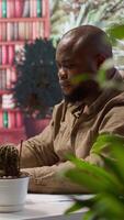 Vertical Successful freelancer using his laptop for remote business tasks, demonstrating effective telecommuting activity from home office. Focuses on data finances and project management. Camera A. video