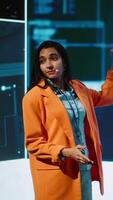 Vertical Speaker talking on stage in event bringing together leading experts, researchers, innovators and companies from around the globe to explore latest developments in AI and machine learning, camera A video
