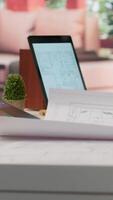 Vertical Owner of a tech startup searching for new office spaces by using blueprints to plan the construction and renovation of the corporate building. Evaluating and reviewing workplace drafts. Camera A. video