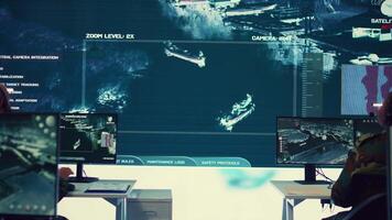 Army personnel applying national safety protocols by verifying all ships anchoring in the coastal ports, using radar surveillance on big screen in military command post. Federal operations. Camera B. video