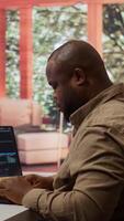 Vertical Software engineer coding on a laptop focusing on deep learning, database management and binary code to develop next generation AI solutions and interfaces. Database processing. Camera B. video