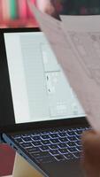 Vertical Businessman searching for commercial office spaces from his home workstation, doing a blueprints review and drafting building layouts to find the perfect startup property. Real estate. Camera A. video