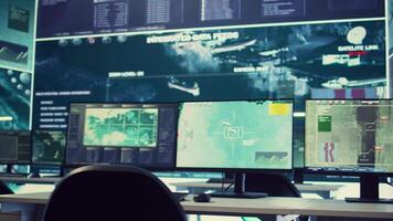 Government anti terrorism operation room equipped with a big display and surveillance on satellite radar cctv used for reconnaissance. Empty military command center with high tech. video