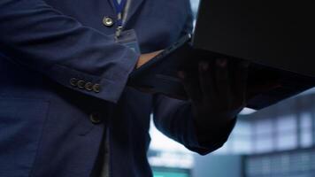 Admin in data center runs system diagnostic tests and error checking utilities on laptop to fix problems. Close up shot of worker looking for network issues affecting rigs performance, camera A video