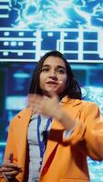 Vertical Speaker talking on stage in event bringing together leading experts, researchers, innovators and companies from around the globe to explore latest developments in AI and machine learning, camera B video