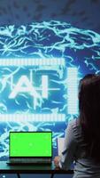 Vertical AI developers using isolated screen device for business data analysis. IT department staff members work on chroma key notebook to automatize tasks using artificial intelligence, camera B video