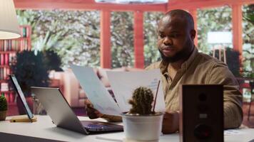 Business owner looks into project development online from home office setup, working on new strategies. Freelancer analyzing data statistics and reports on laptop, telecommuting methods. Camera B. video