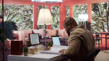 Owner of a tech startup searching for new office spaces by using blueprints to plan the construction and renovation of the corporate building. Evaluating and reviewing workplace drafts. Camera B. video