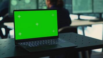 Laptop showing green screen in a governmental high tech office, cyber security team working on network security and data protection. Focusing on ransomware and other cyber threats. Camera A. video