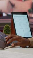 Vertical Professional entrepreneur examining blueprints and using digital tools for office space planning and development. Business owner workspace design for renting, investment strategy. Camera A. video