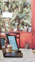 Vertical Empty modern home workstation of an entrepreneur with laptop and tablet, financial analytics data studied for startup investment and development. Remote job in business industry. video