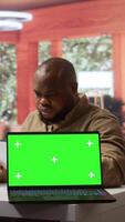 Vertical Startup administrator calculates economic budget balance at his home office, using isolated chroma key green screen. Entrepreneur reviews monthly sales reports, investment funds. Camera B. video