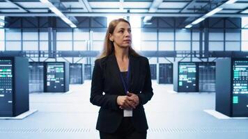 Admin walking in data center, monitoring systems to identify root cause of errors. IT specialist in server farm establishment doing diagnosis, looking for equipment bugs in need of repairing, camera B video