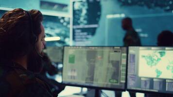 Commander communicating with allied forces and transmitting data from surveillance footage, coordinating joint operations and strategies to accomplish mission. Satellite radar operator. Camera B. video