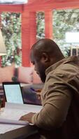Vertical Owner of a tech startup searching for new office spaces by using blueprints to plan the construction and renovation of the corporate building. Evaluating and reviewing workplace drafts. Camera B. video