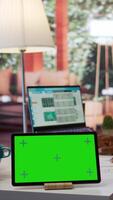Vertical Financial expert reviews business statistics next to a chroma key screen, analyzing budget balance to ensure a correct economic situation report. Entrepreneur examines data analytics. Camera B. video