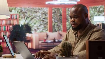 Business consultant creating infographics and managing business reports on laptop, showcasing modern working strategies. Developing a startup project and reviewing financial statistics. Camera B. video