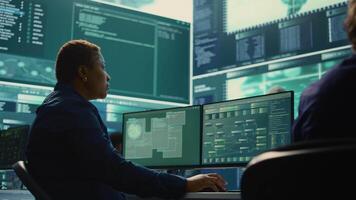 Cyber security expert working on encryption and IT security in a governmental agency. Woman engaging on cyber operations, network security and data protection for hybrid war. Camera B. video