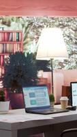Vertical Empty home setup with tablet and laptop showing financial statistics and annual sales reports, business industry infographics. Office desk used for a consultant to study the market dynamics. video