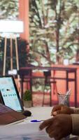 Vertical Businessman reviewing the financial reports with the shareholders on a videocall meeting at home. Specialists analyzing expansion plans to provide new business funds. Startup growth. Camera B. video