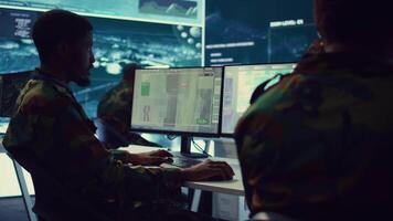 Soldier implements and processes tactical data with reconnaissance radar system, creating comprehensive battlefield maps to aid troops in the operational field. Intelligence for a mission. Camera B. video